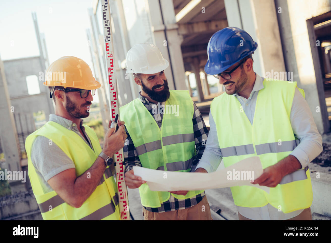 Portrait of construction engineers working on building site Stock Photo