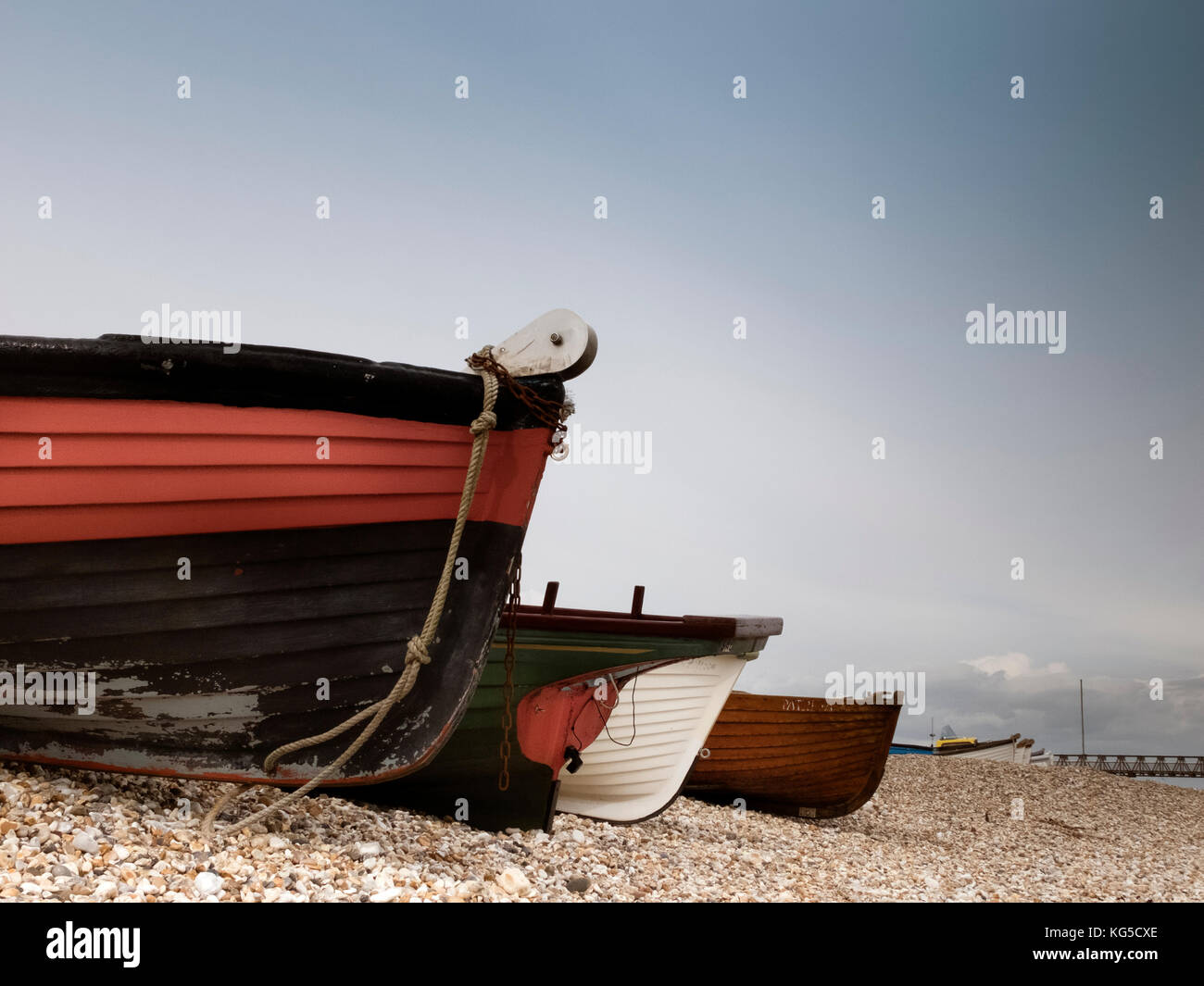 Small clinker boats on a shingle back at Selsey Bill, Sussex Stock Photo