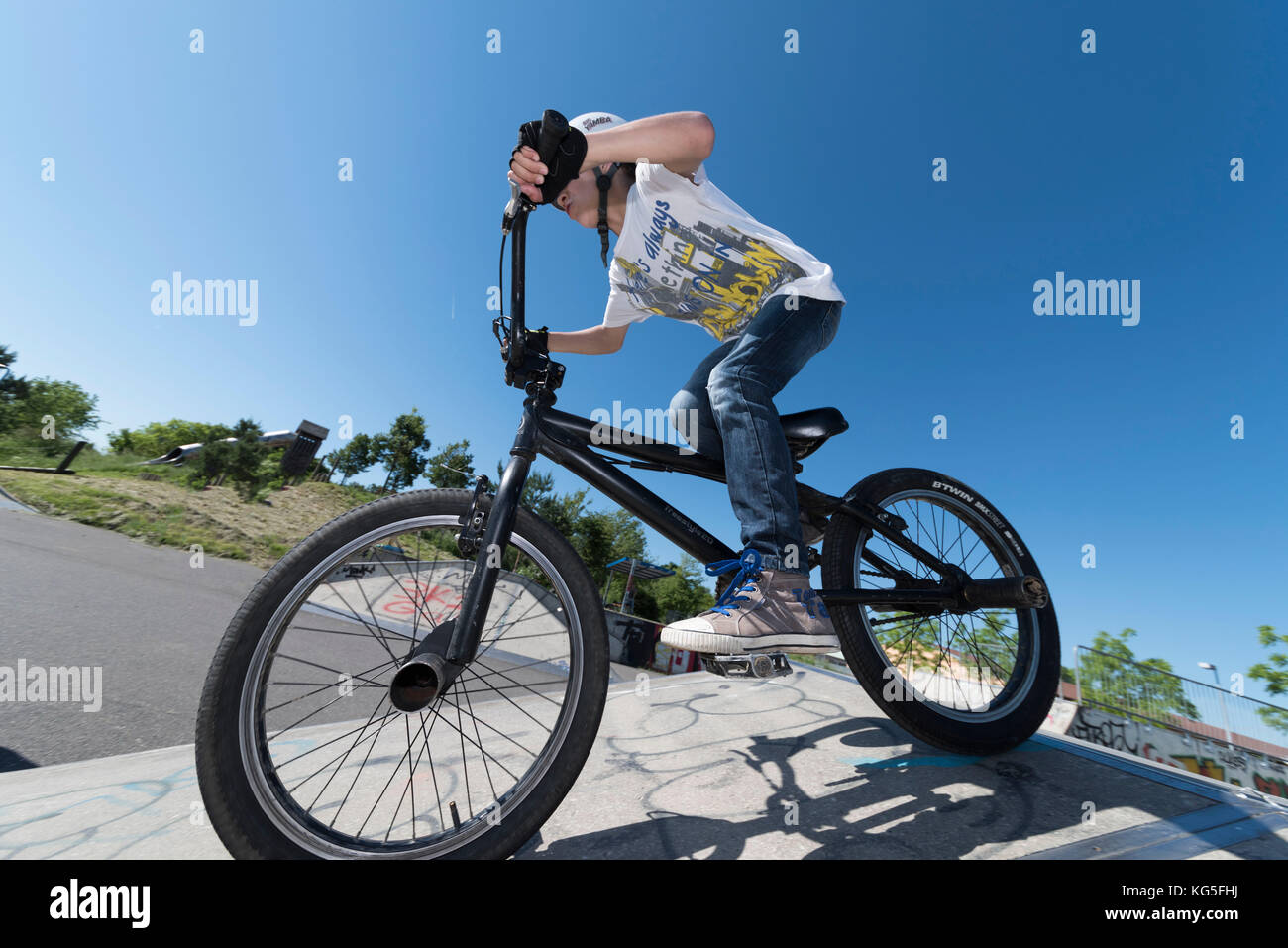 Boy on BMX bike in the skate park Stock Photo