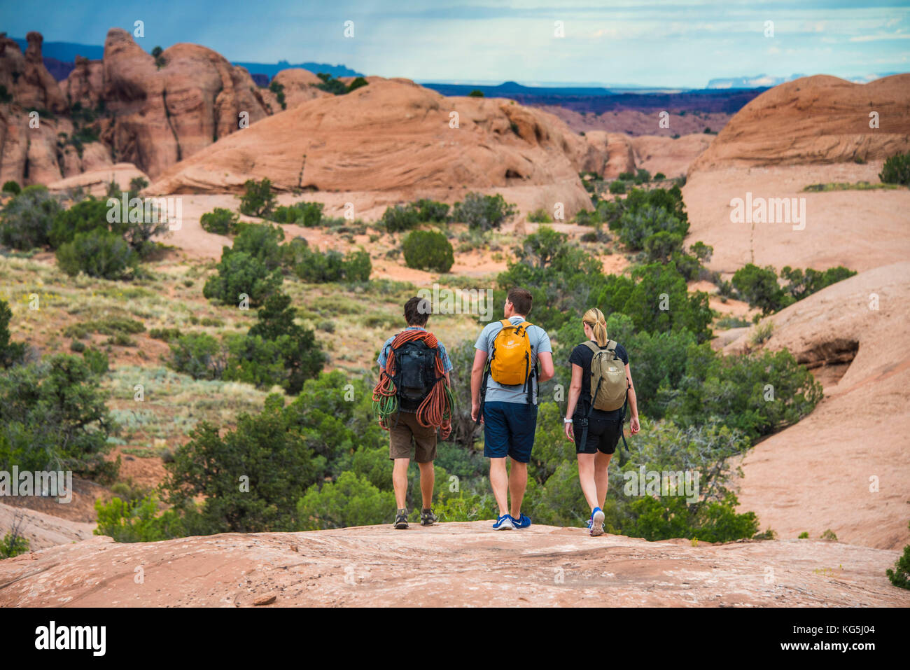 Trekkers walking along the slick rock trail near, Moab, Utah, USA Stock Photo