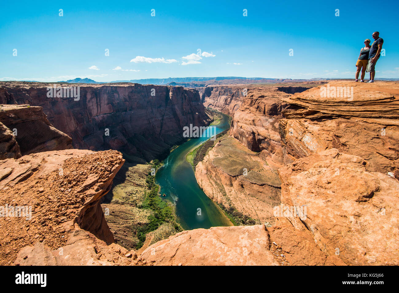 Tourists standing on top of the Horseshoe bend on the Colorado river at the south rim, Arizona, USA Stock Photo