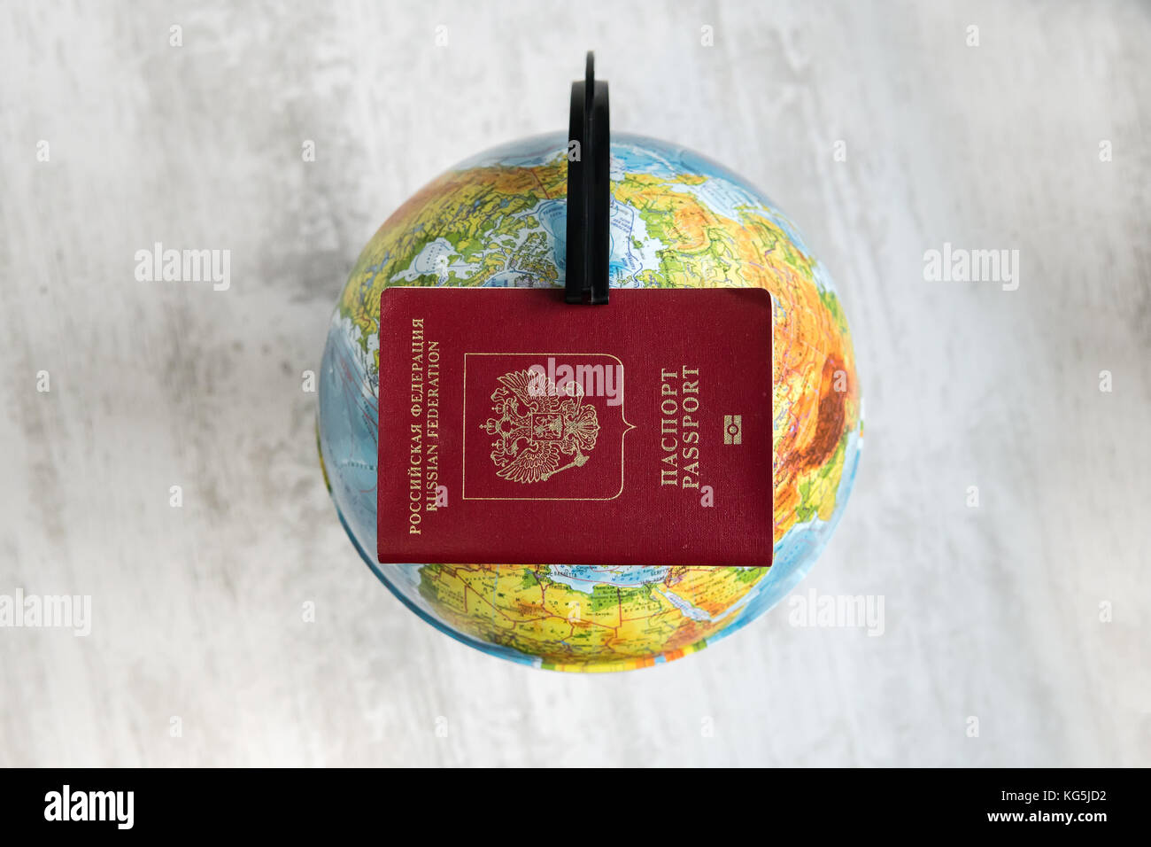 Well traveled passport in front of a map or globe of planet earth. The passport of the Russian Federation lies on the globe. The concept of travel and Stock Photo