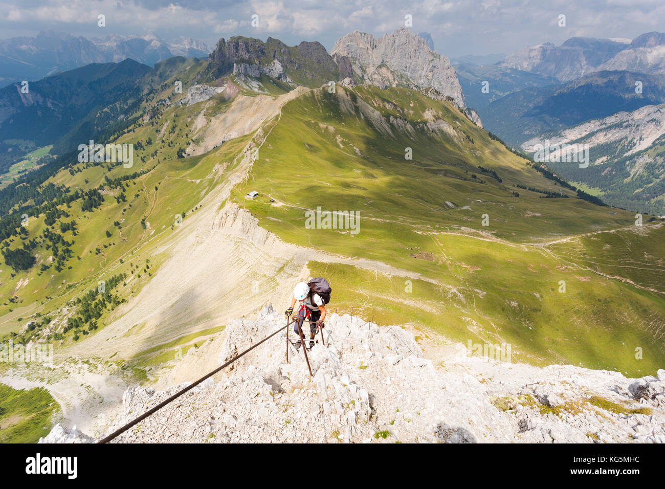 a hiker is climbing a very hard via ferrata, Trento province, Trentino Alto Adige, Italy Stock Photo