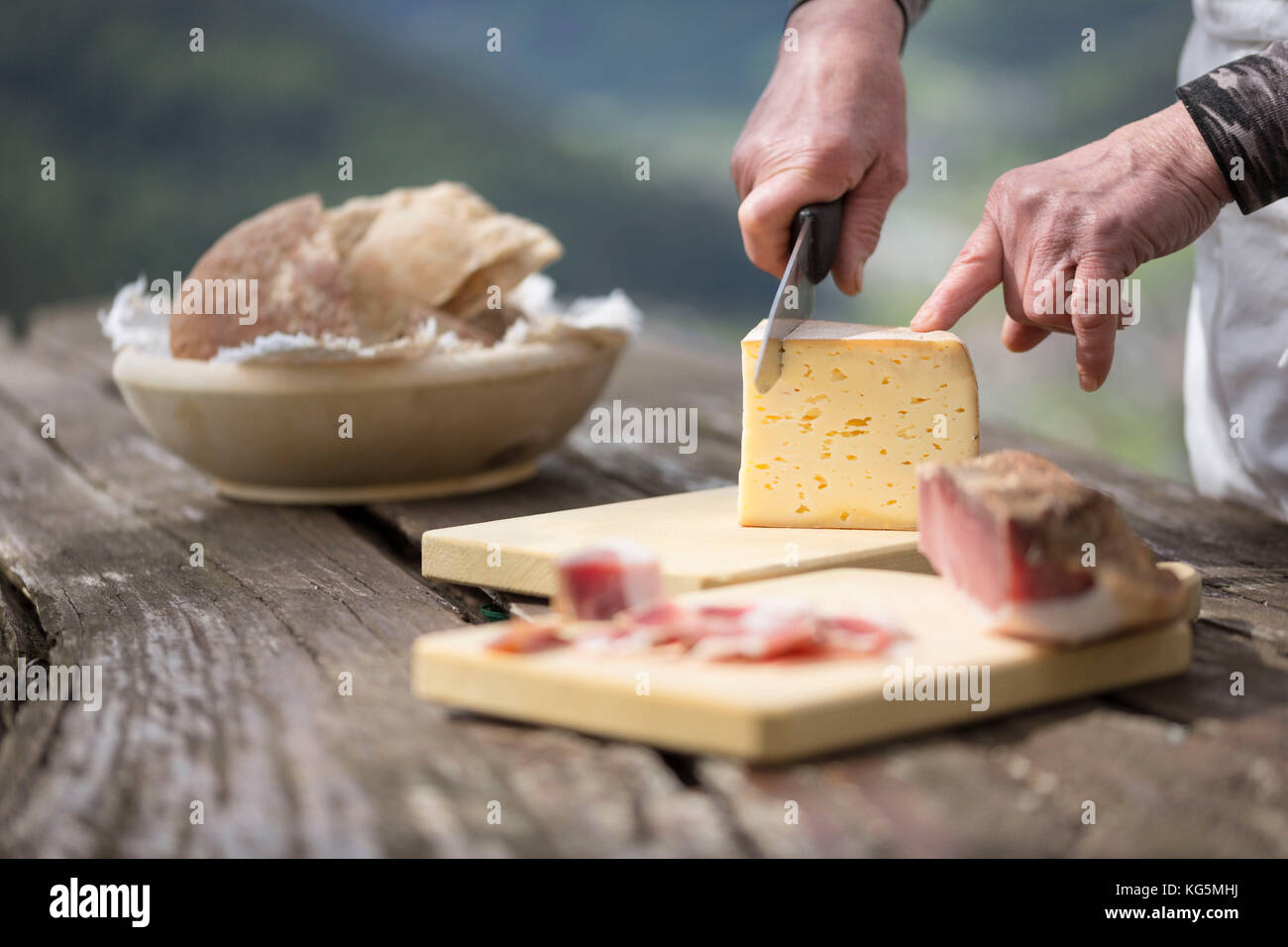 a chef is cutting a piece of cheese, Bolzano province, South Tyrol, Trentino Alto Adige, Italy, Stock Photo