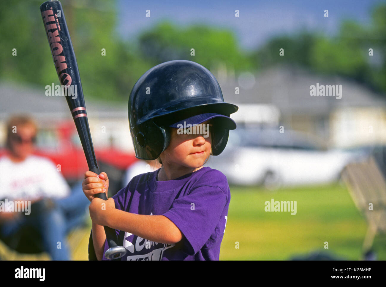 A young girl playing Little League Baseball, waits for a pitch from the pitcher. Stock Photo