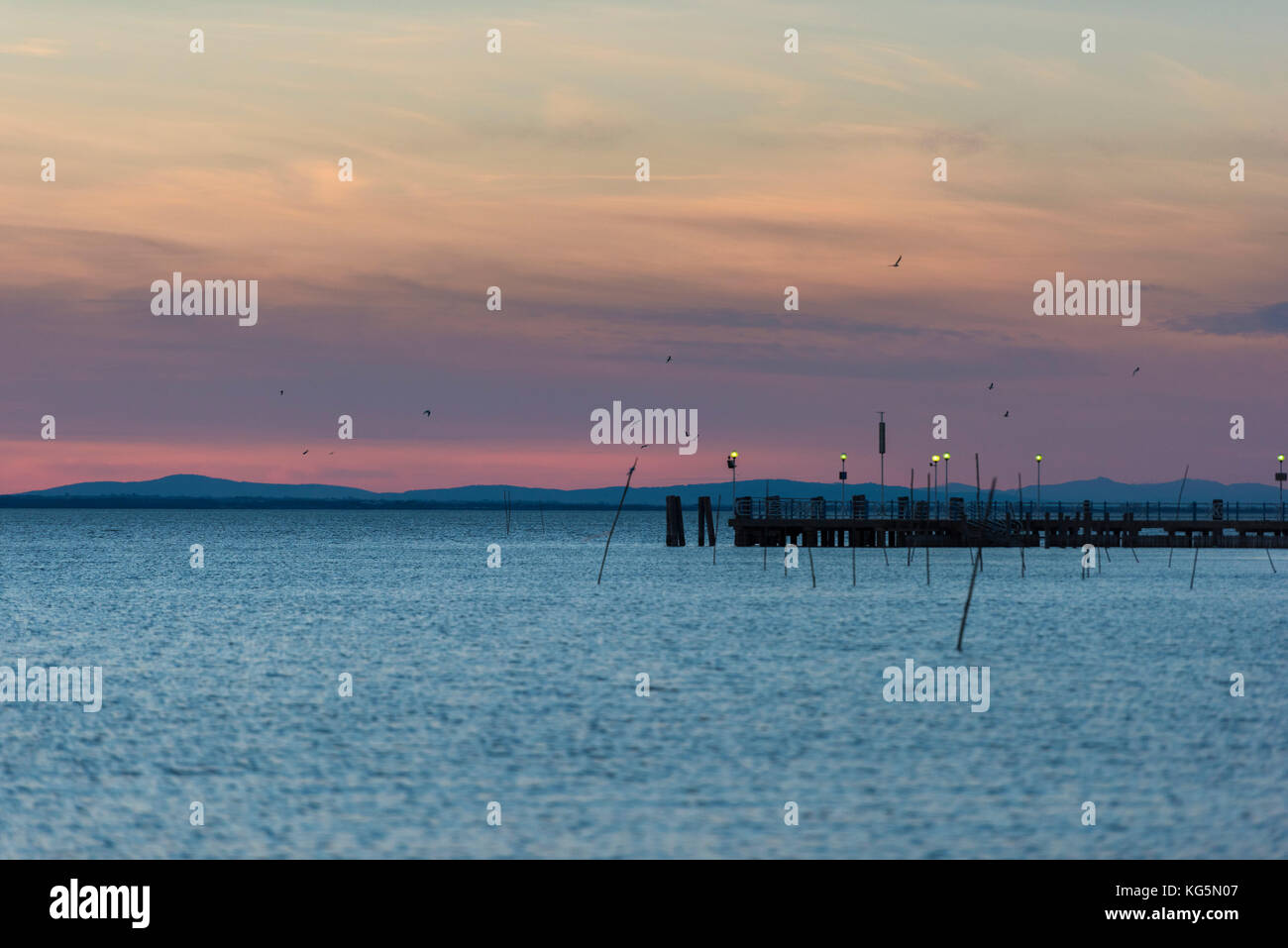 Italy, Umbria, Perugia, Lake Trasimeno, Pier at sunset Stock Photo