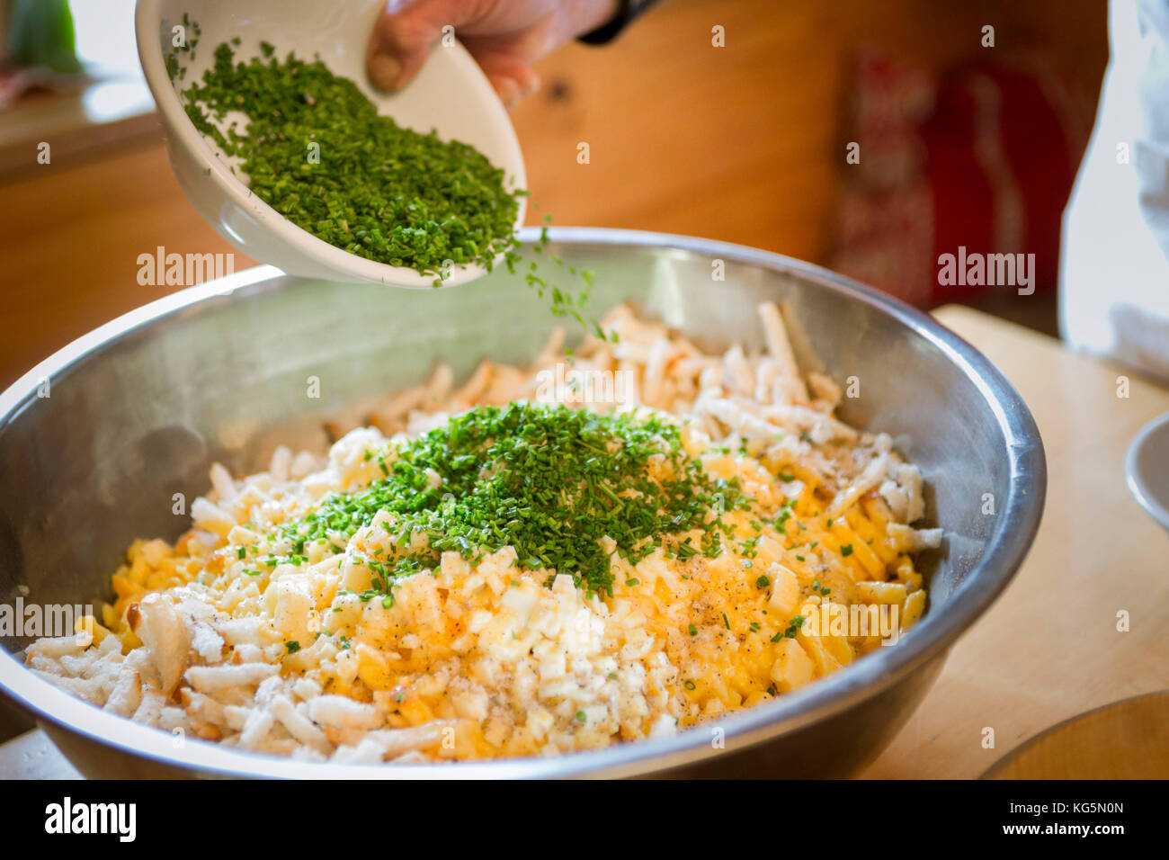 a Chef is preparing a traditional local food with eggs, brot, and chives, Bolzano province, South Tyrol, Italy Stock Photo