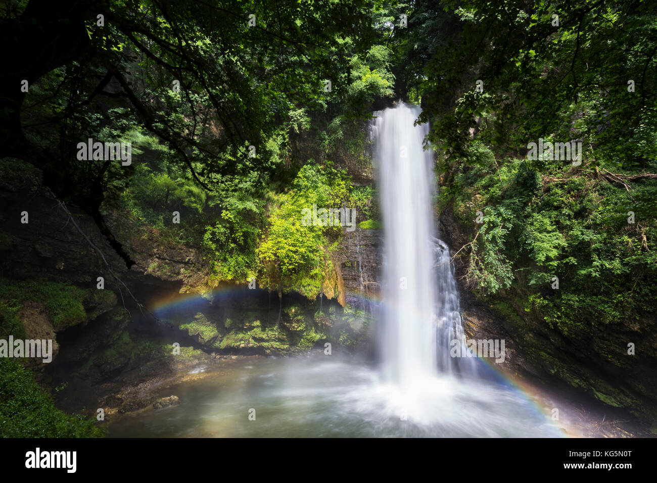 Ferrera waterfall creating a rainbow in spring, Ferrera di Varese, Lombardy, Italy. Stock Photo