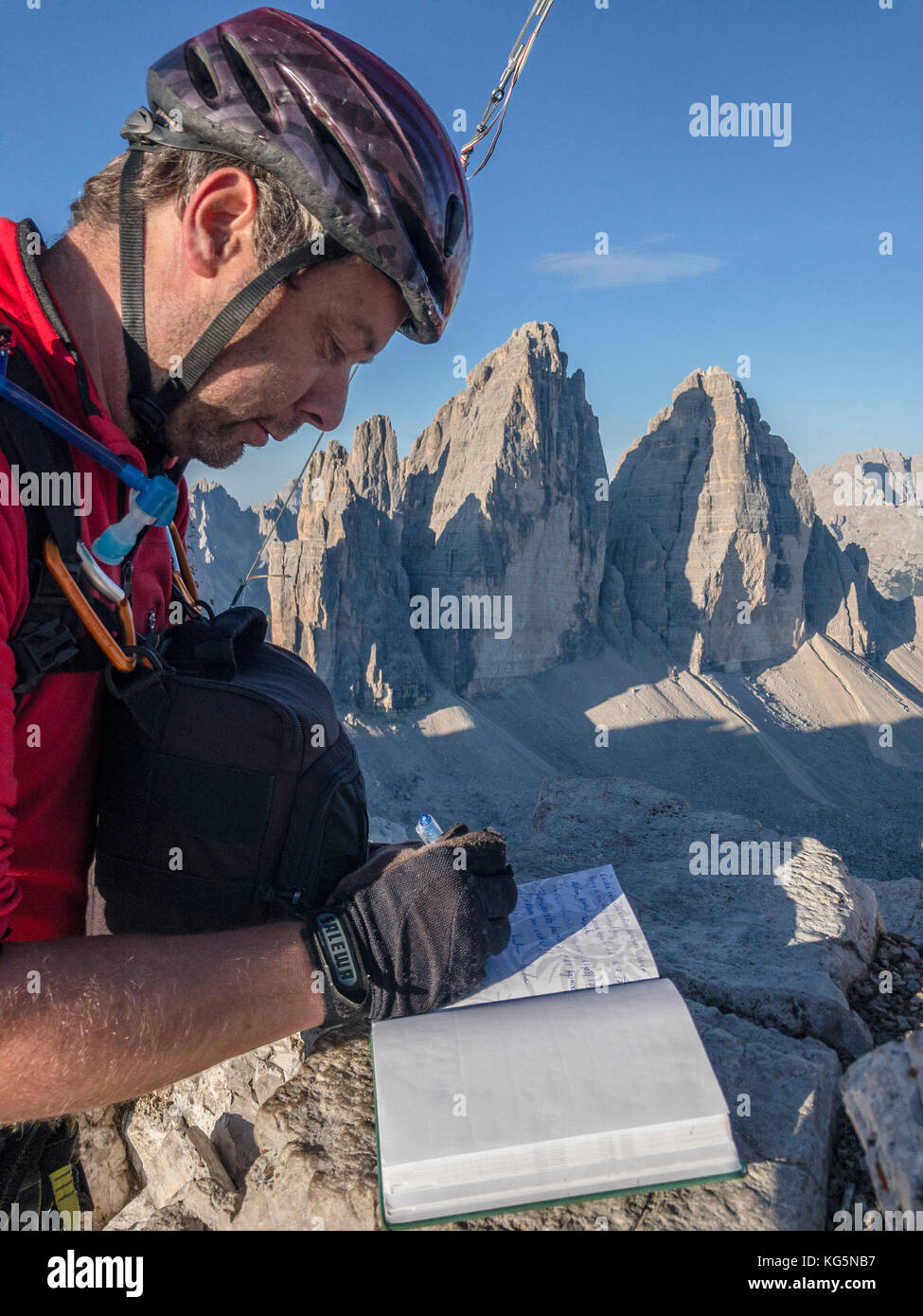 Sesto/Sexten, Dolomites, South Tyrol, province of Bolzano, Italy. Hiker sign the book of the summit of Monte Paterno/Paternkofel on the Tre Cime di Lavaredo/Drei Zinnen Stock Photo