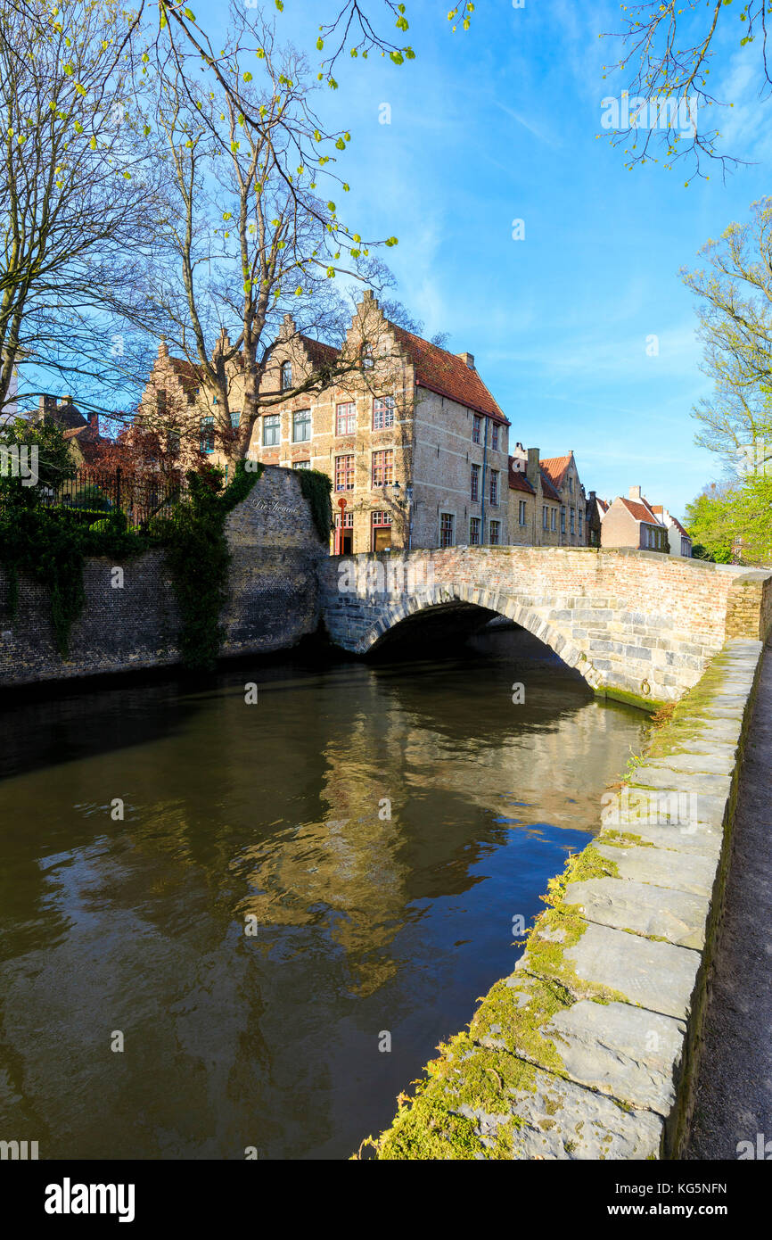 Historic buildings of the city centre framed by old bridge of the typical canal Bruges West Flanders Belgium Europe Stock Photo