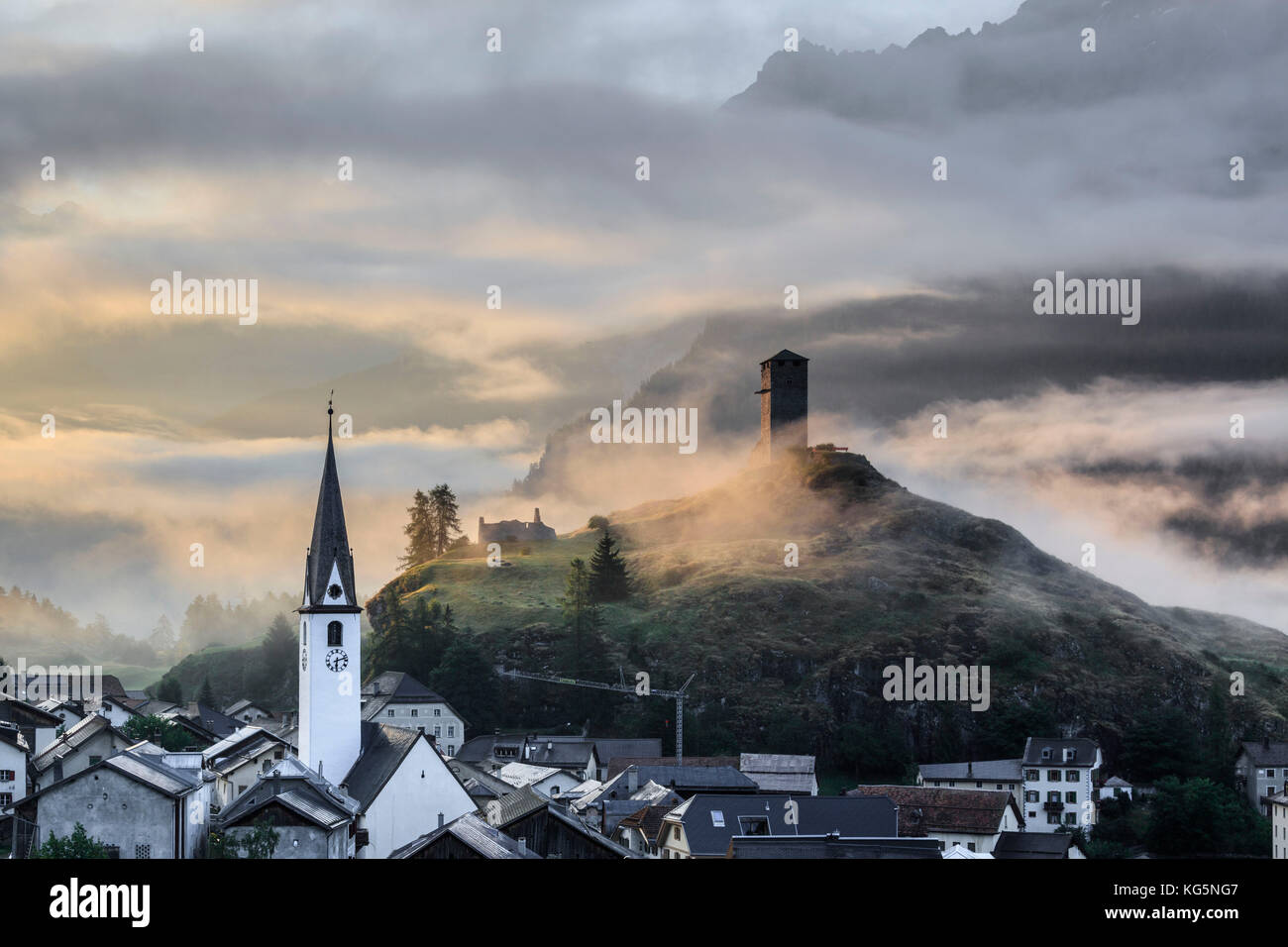 Misty sky on the alpine village of Ardez at sunrise, canton of Graubünden, district of Inn, lower Engadine, Switzerland, Europe Stock Photo