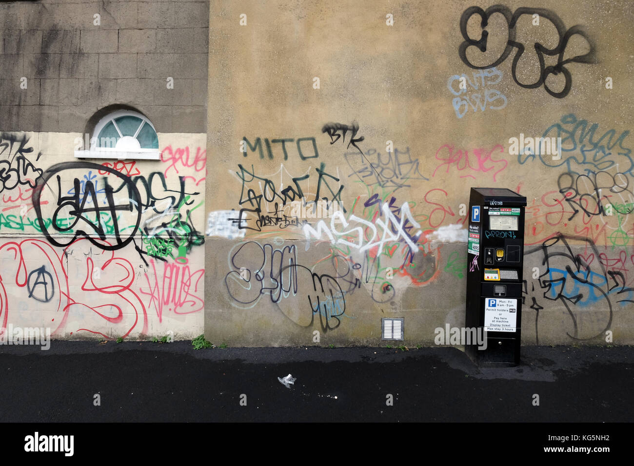 A graffiti covered wall and a parking meter machine Stock Photo - Alamy