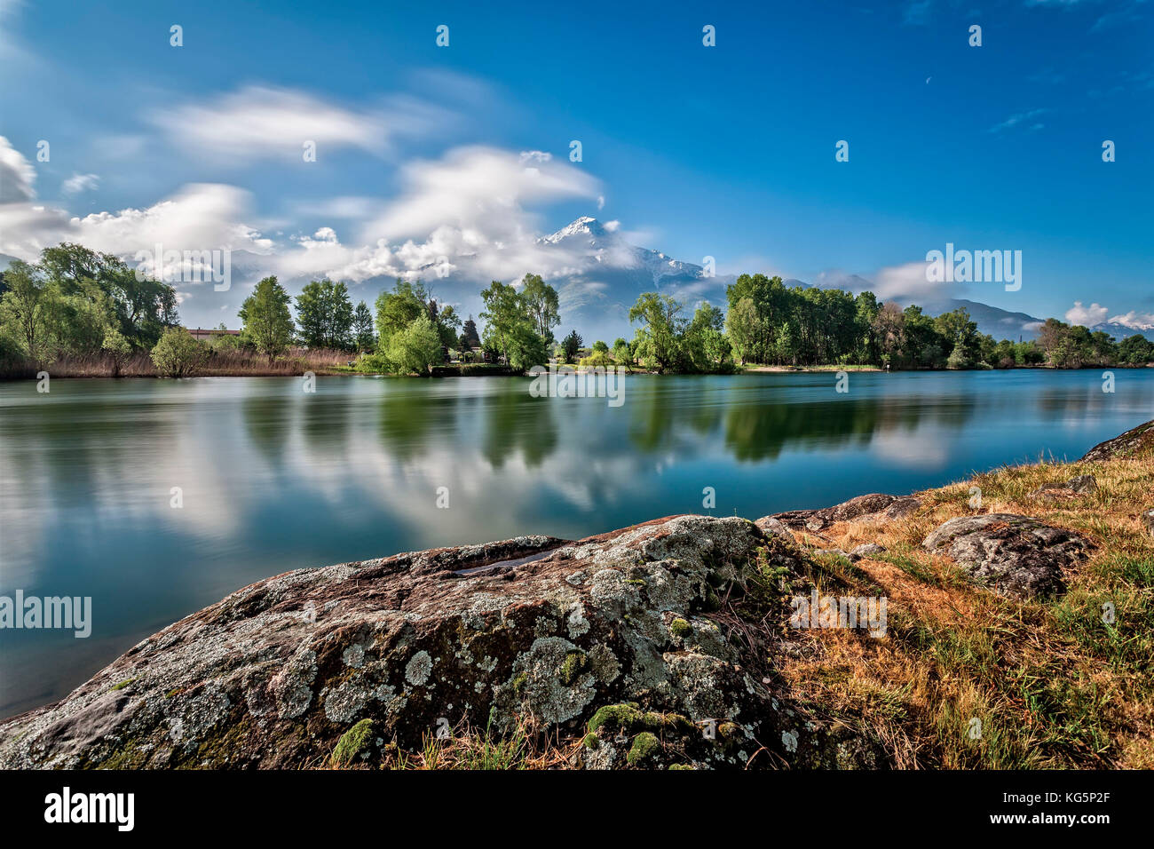 river Mera, Lake Como, Mountain, Legnone, trees, reflection, lombardy, italy Spring colouurs on Mera river from Dascio with Mount Legnone in the background still covered by snow, province of Como, Lombardy, Italy, Europe Stock Photo