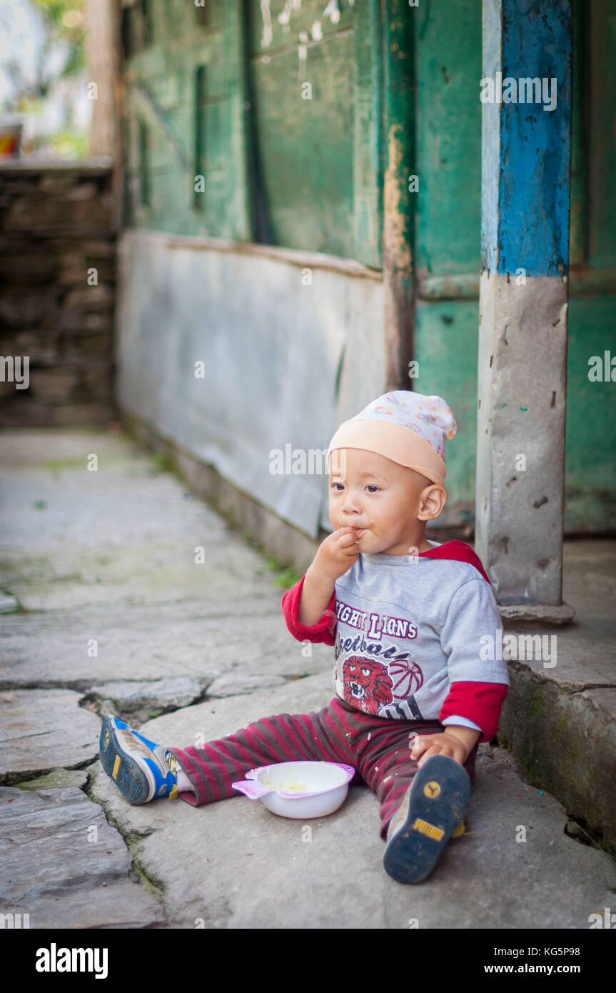 Breakfast time for this cute baby, Annapurna region, Nepal, Asia Stock Photo