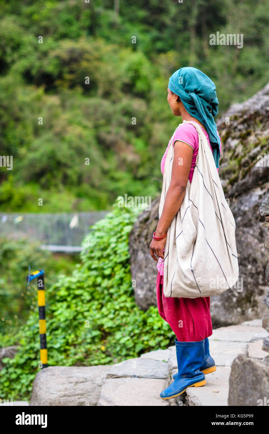 Young woman is getting ready to work in the fields, Annapurna region, Nepal, Asia Stock Photo