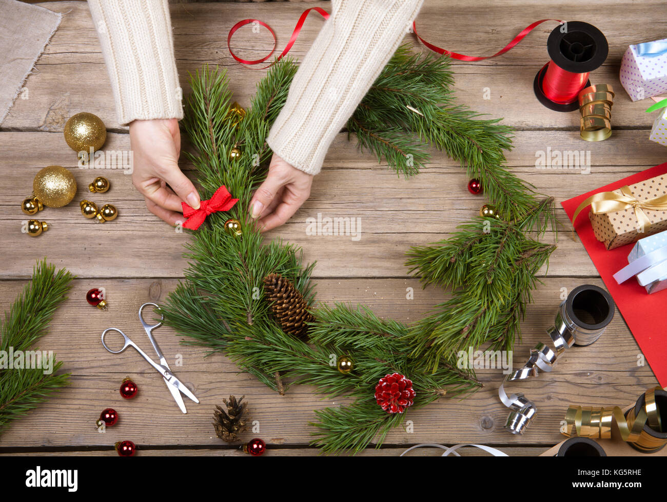 Woman is making Christmas wreath. Top view Stock Photo