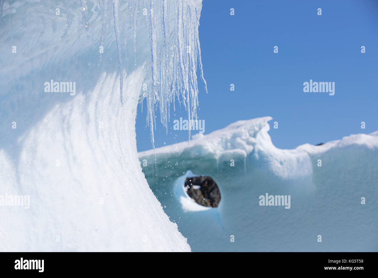 Antarctic Icicles and Iceberg Stock Photo