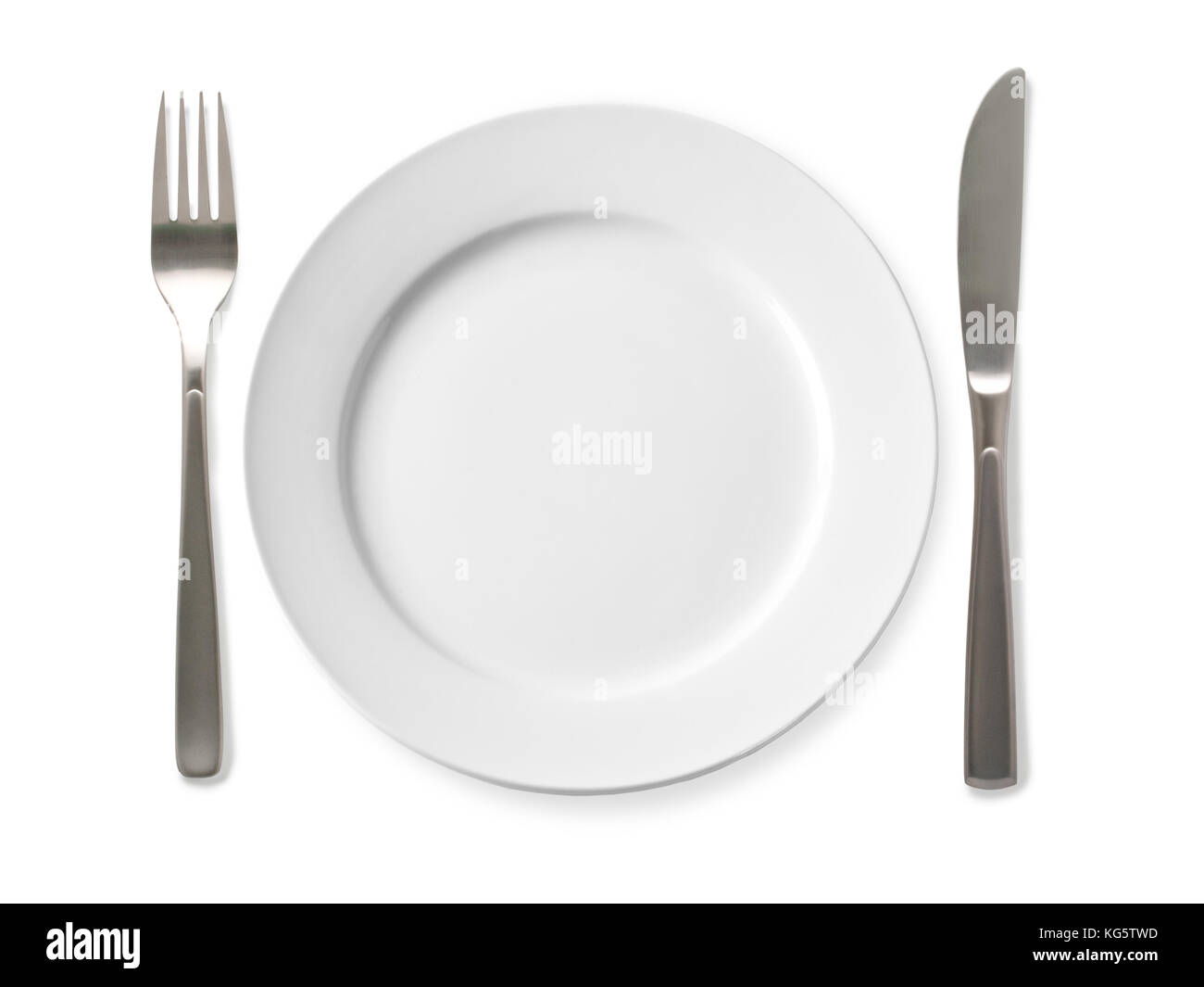 Empty plate with knife and fork on a white background Stock Photo - Alamy