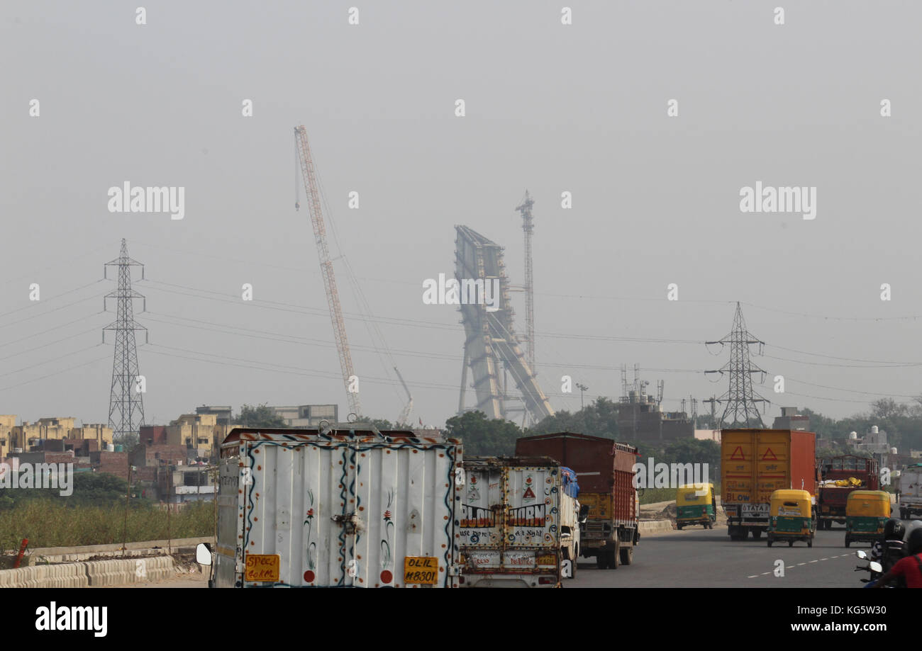 Commercial vehicles on outer ring road, Delhi. Under construction Signature Bridge on the river Yamuna at Wazirabad is also visible. Stock Photo