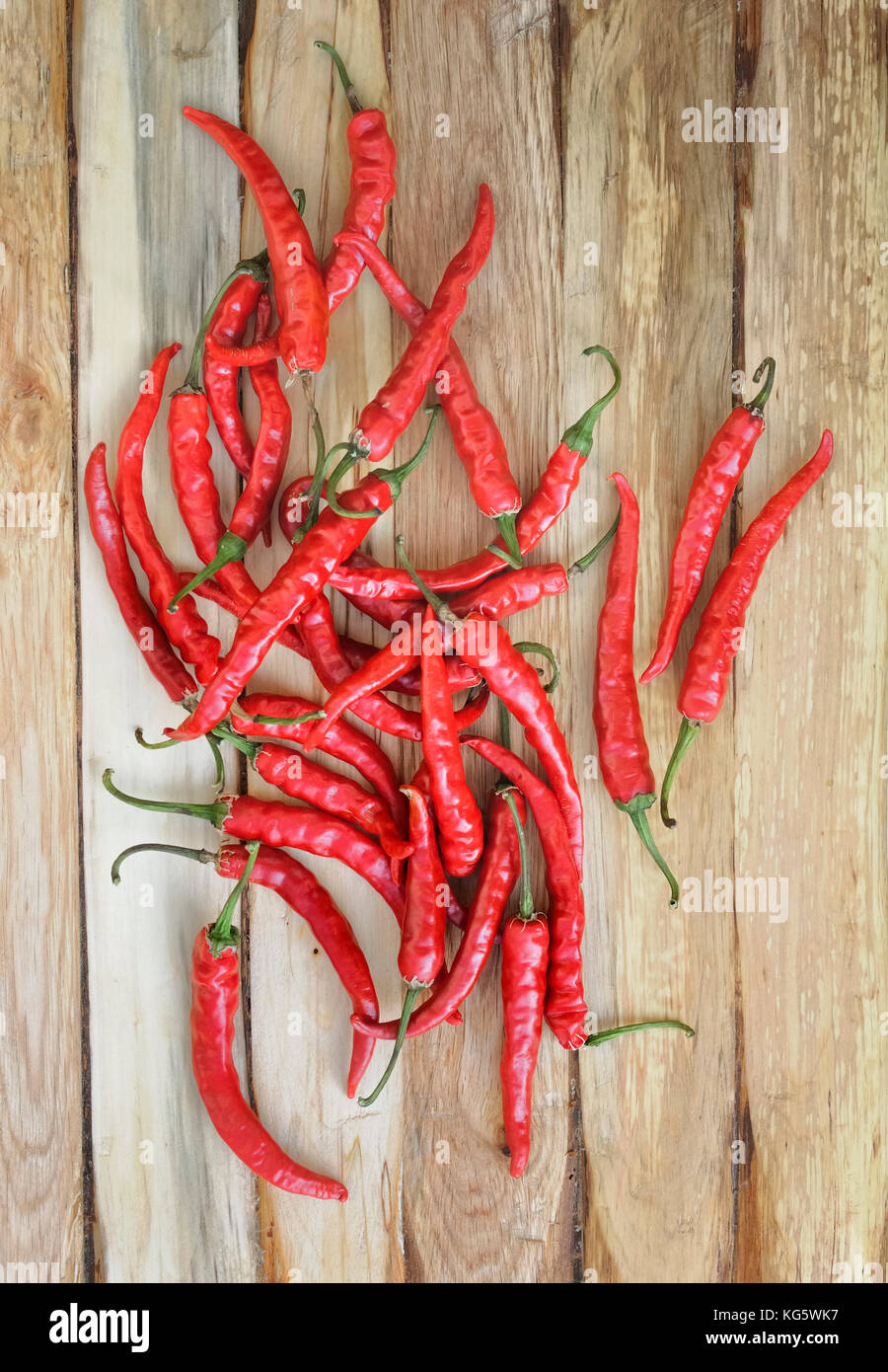 top view on group of red hot chili peppers on a plank Stock Photo - Alamy