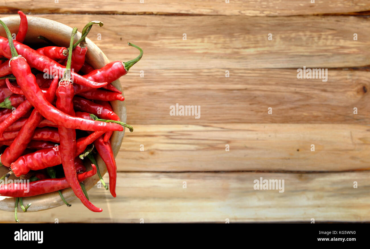 top view on red hot chili peppers on wooden background Stock Photo - Alamy