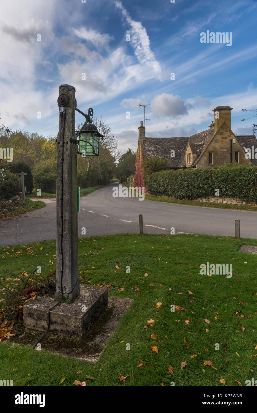 Old lantern post on village green in Stanton, Gloucestershire Stock Photo