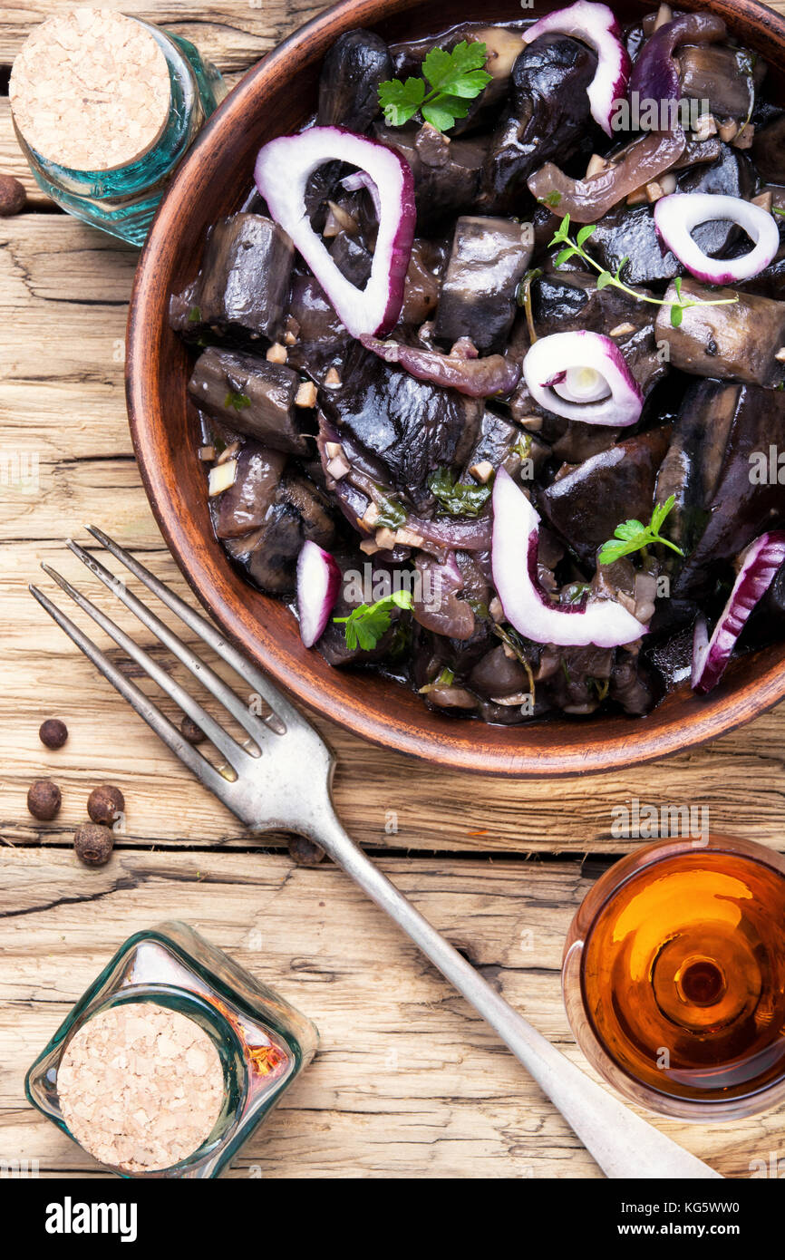 glass of cognac and a snack from forest salted mushrooms Stock Photo