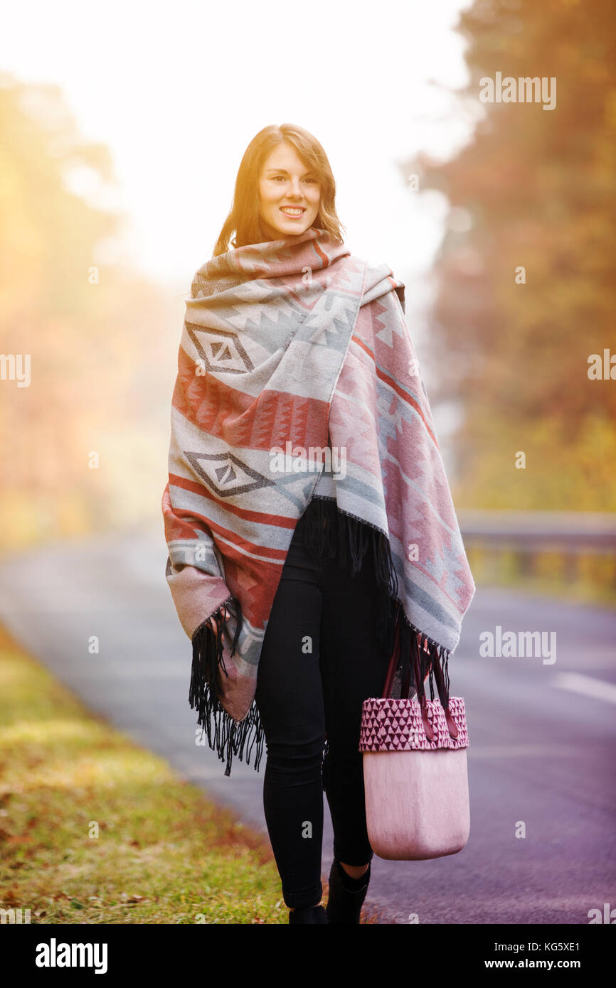 young brunette woman walking on street in autumn Stock Photo - Alamy