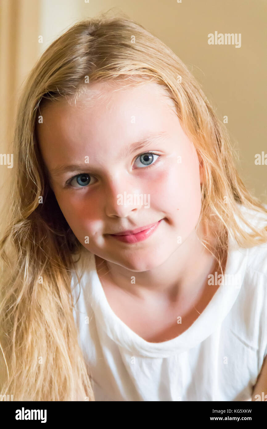 Cute girl with blond long hair and blue eyes Stock Photo - Alamy
