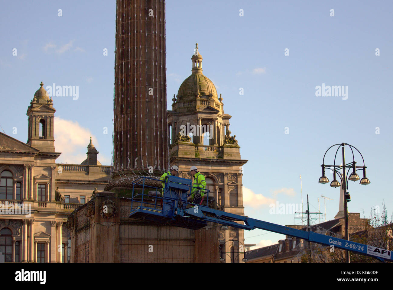 Council workers signal the arrival of the festive season as they prepare t decorations for the christmas  lights in the town's George Square. Stock Photo