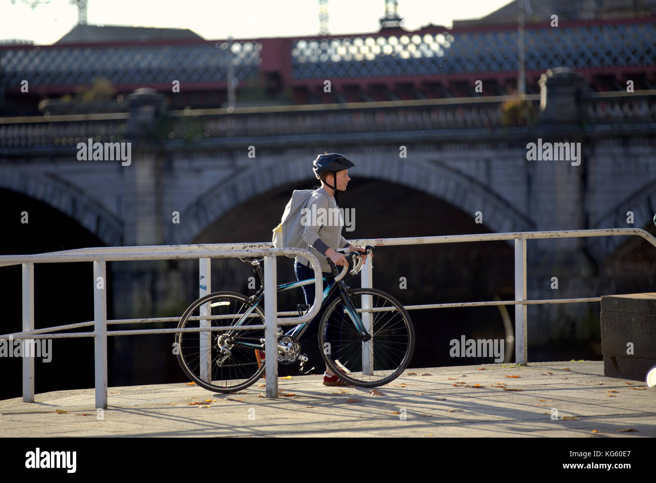 young person boy on bicycle bike dismounted on clyde river cycle path walkway entering street turn off for city centre near king george 5th bridge Stock Photo