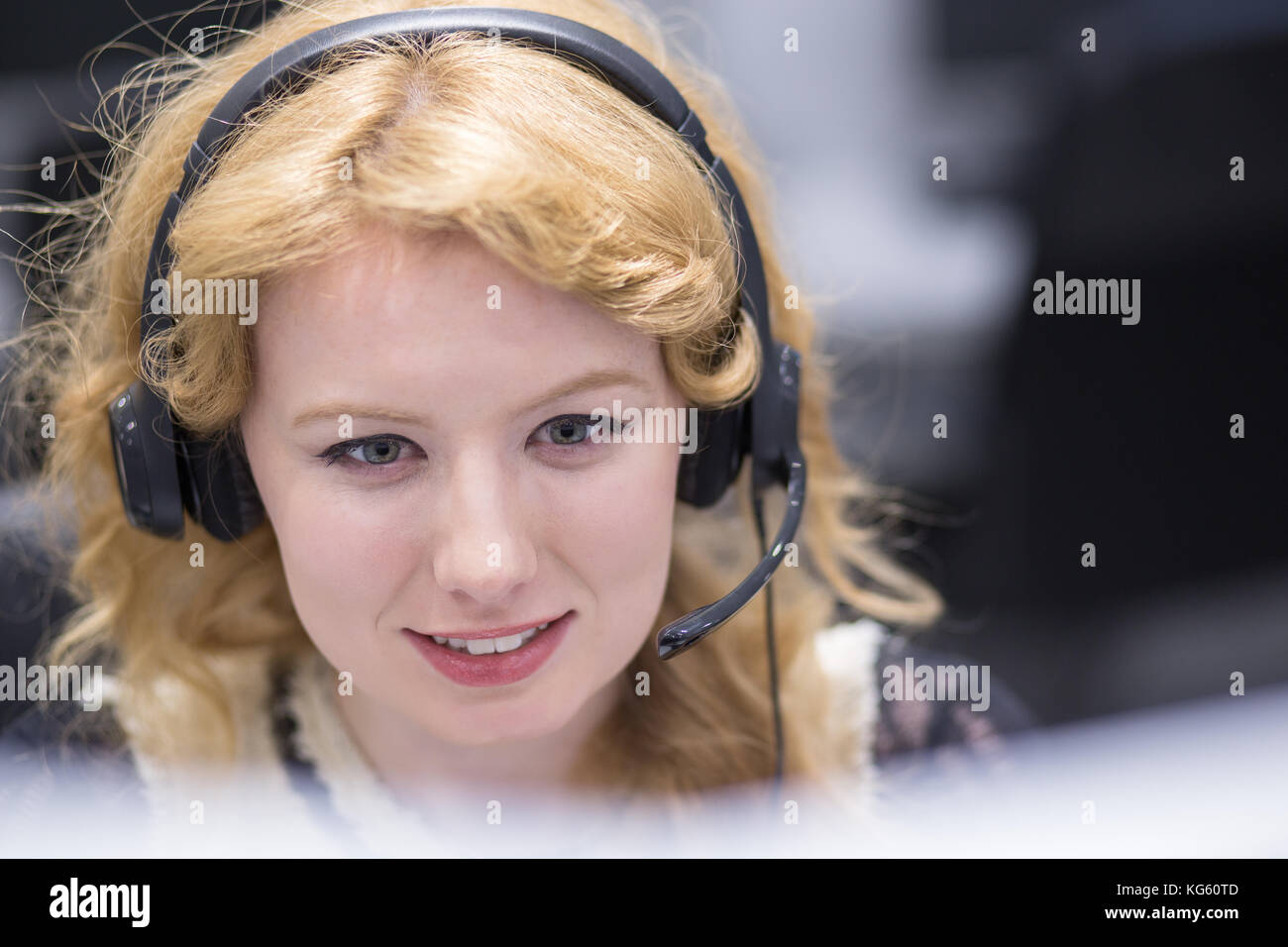 Young Smiling Female Call Centre Operator Doing Her Job With A Headset ...