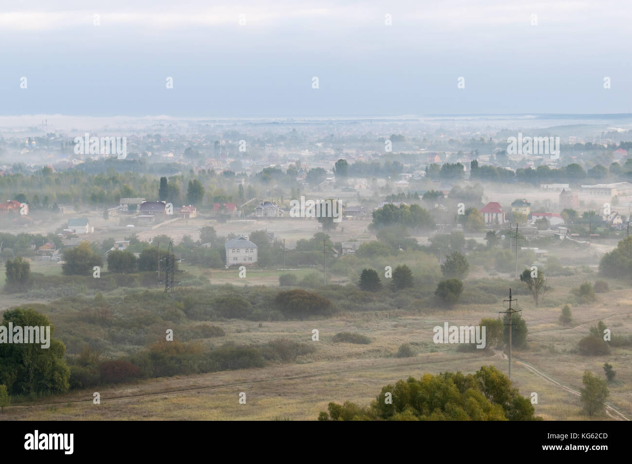 Layer of fog over the village in the valley Stock Photo - Alamy