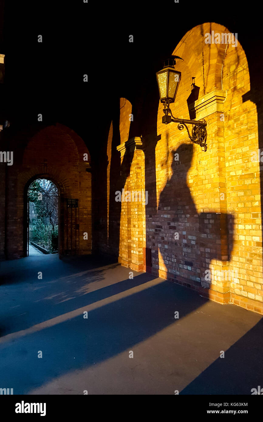 Monk as a shadow under a archway Stock Photo