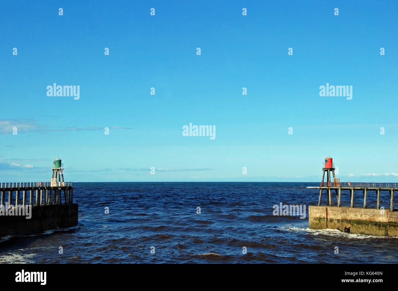 The North Sea seen between the east and west piers through the entrance to Whitby Harbour, North Yorkshire UK Stock Photo