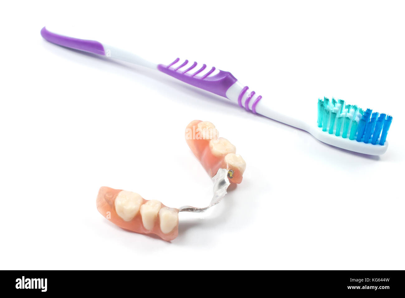 Partial denture with toothbrush isolated on white Stock Photo Alamy