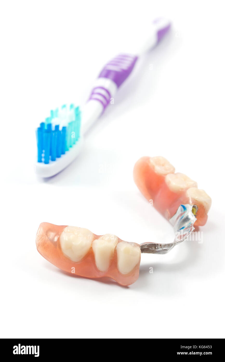 Partial denture with toothbrush isolated on white Stock Photo Alamy