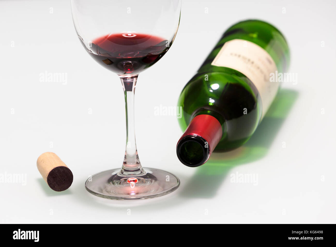 Cup with some red wine, cork and empty bottle Stock Photo
