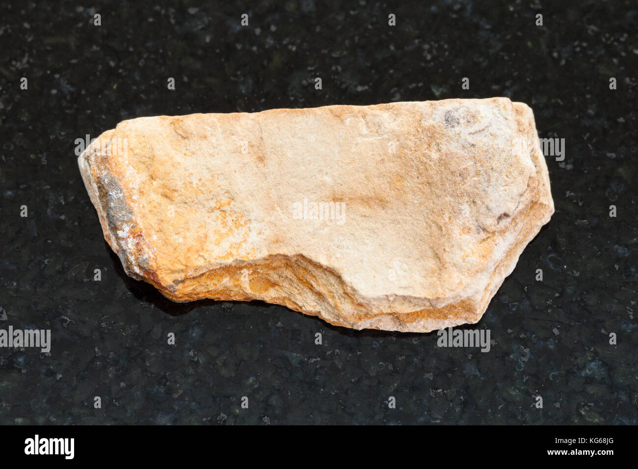 macro shooting of natural mineral rock specimen - rough Shale stone on dark granite background Stock Photo