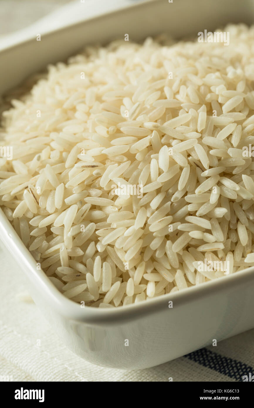 Organic Dry Long Grain White Rice in a Bowl Stock Photo