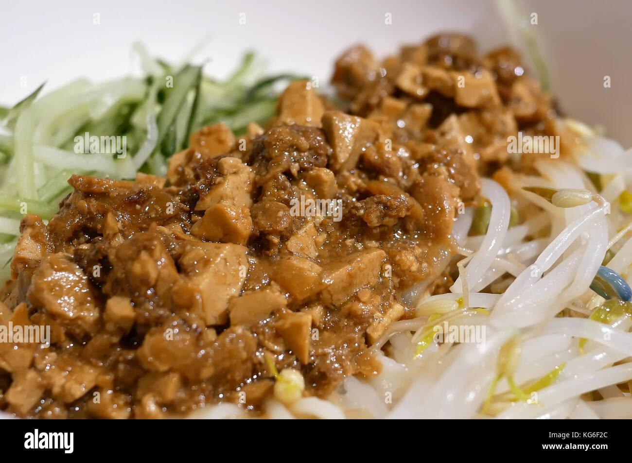 Motion of noodles with fried bean and meat sauce inside Chinese restaurant Stock Photo