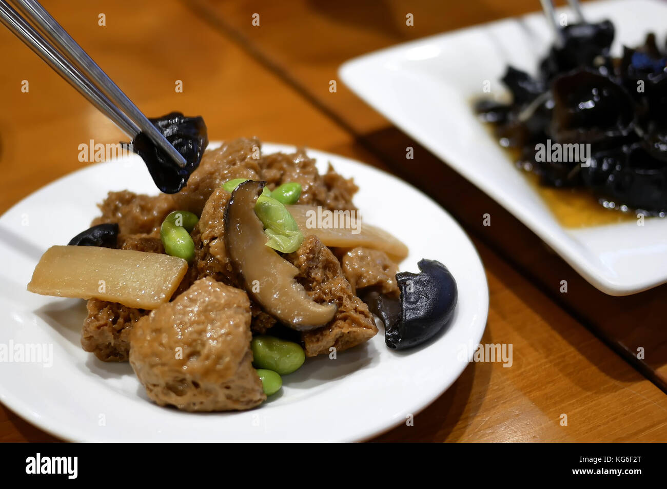 Motion of people eating appetizers on table inside Chinese restaurant