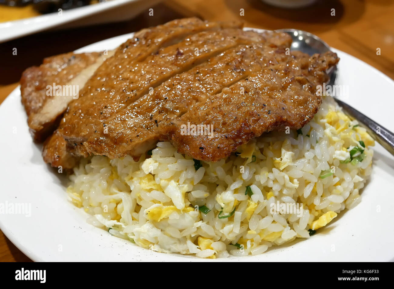Motion of fried rice with fried pork on table inside Chinese restaurant Stock Photo