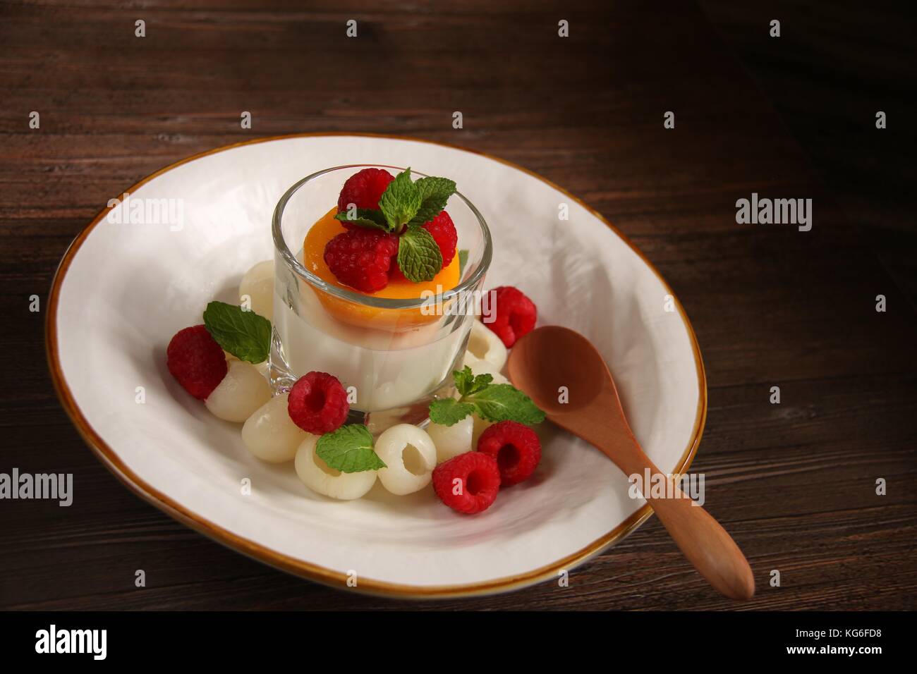 Almond Milk Pudding with Longan, Peach and Raspberry Stock Photo