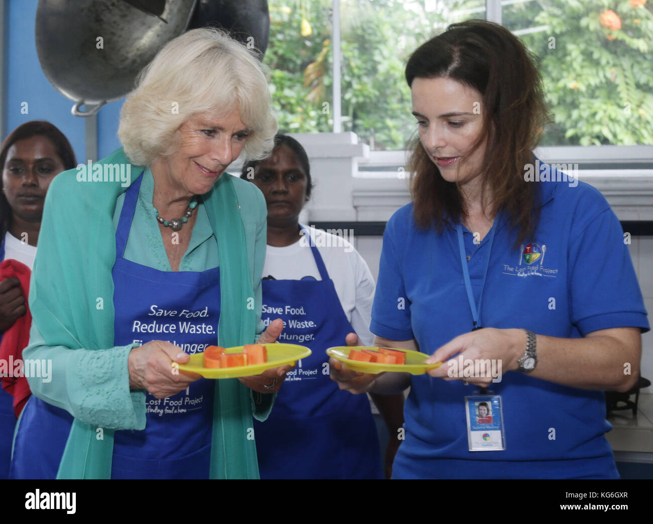 The Duchess of Cornwall (left) and the project's Chairwoman and Founder, Mrs Suzanne Mooney, prepare food for residents of The Lighthouse Children's Welfare Centre, during her visit to The Lost Food Project - the first professional food bank in Malaysia, reclaiming high quality surplus food from supermarkets and manufacturers, sorting and distributing them to a wide variety of charities on a non-discriminatory basis - in Kuala Lumpur, Malaysia. The Lighthouse Children's Welfare Home houses 60 disadvantaged children, aged one to 18 years old. Stock Photo
