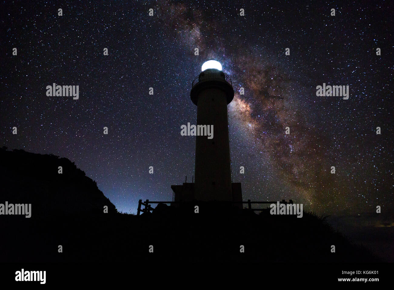 The Milky Way on a clear night with the Uganzaki Lighthouse in the foreground Stock Photo