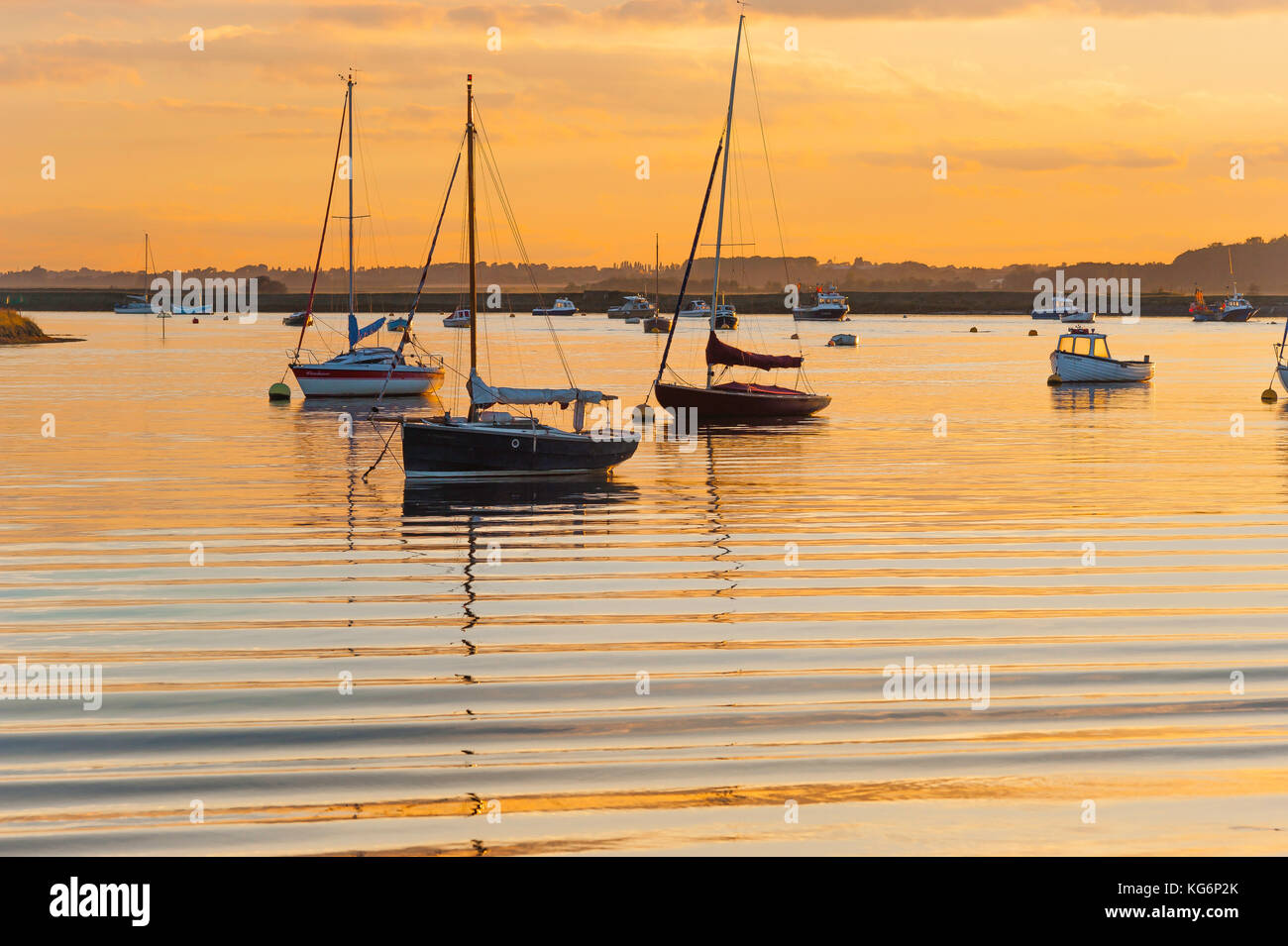 Suffolk UK river, view at sunset of sailing boats moored in the River Alde near Orford, Suffolk, UK Stock Photo