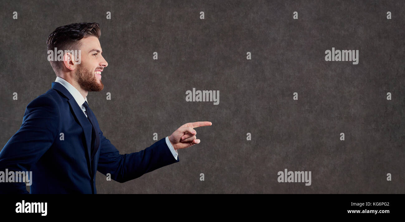 Businessman points to copyspace background Stock Photo - Alamy