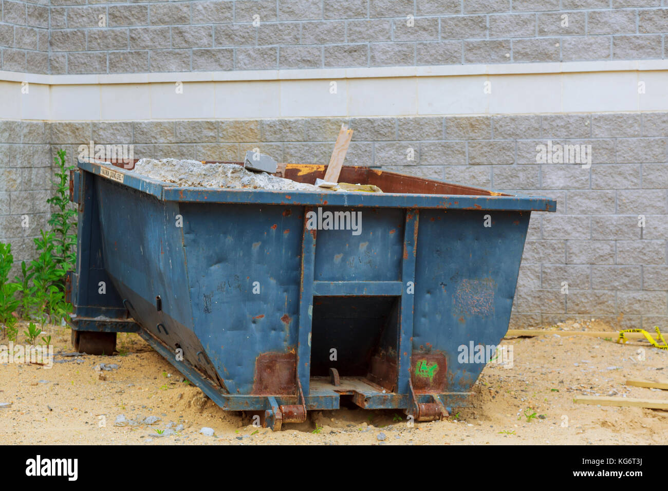Industrial dumpster filled Loaded dumpster near a construction site
