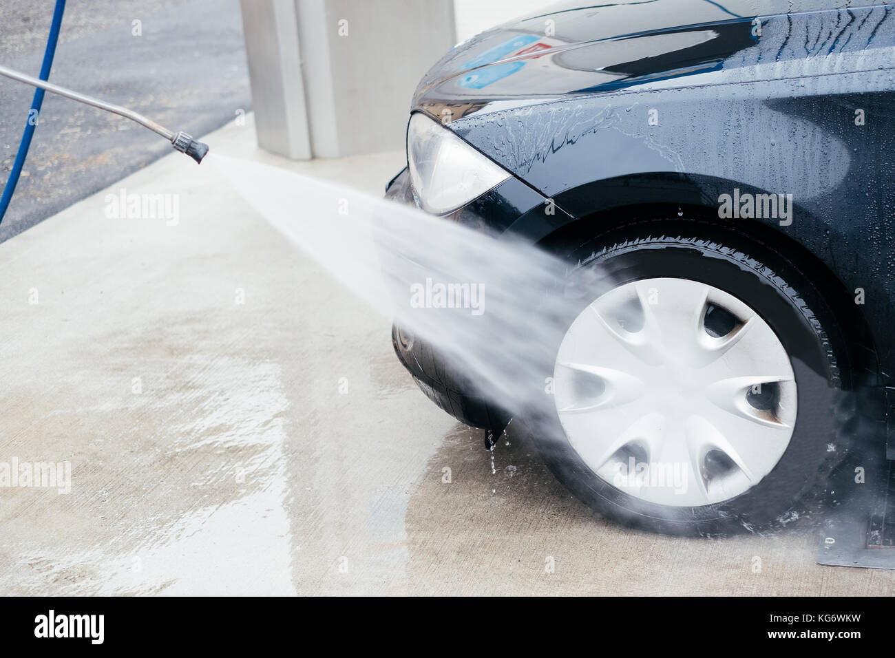Pressure water jet cleaning a car wheel Stock Photo Alamy